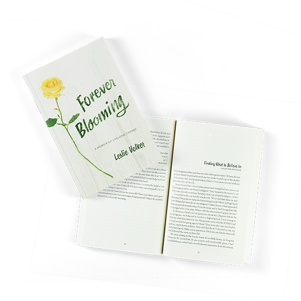 The "Forever Blooming" cover with it's yellow rose. The closed book is laying on top of another copy open to a chapter page.