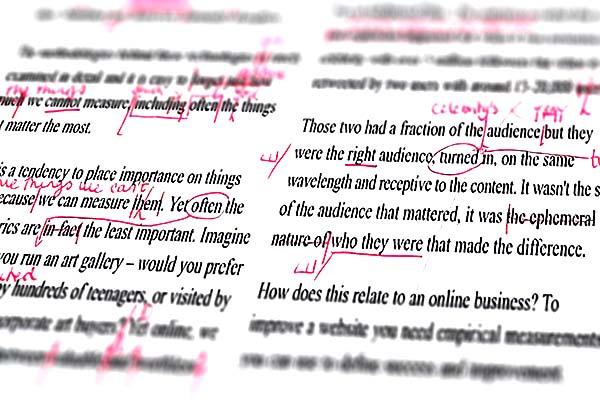 Closeup view of red proofreader markup on a document.