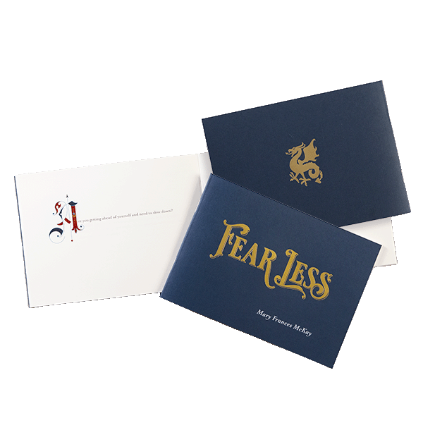 Dark blue front and back cover featuring gold foil, along with an interior page showing an ornate script initial "A."