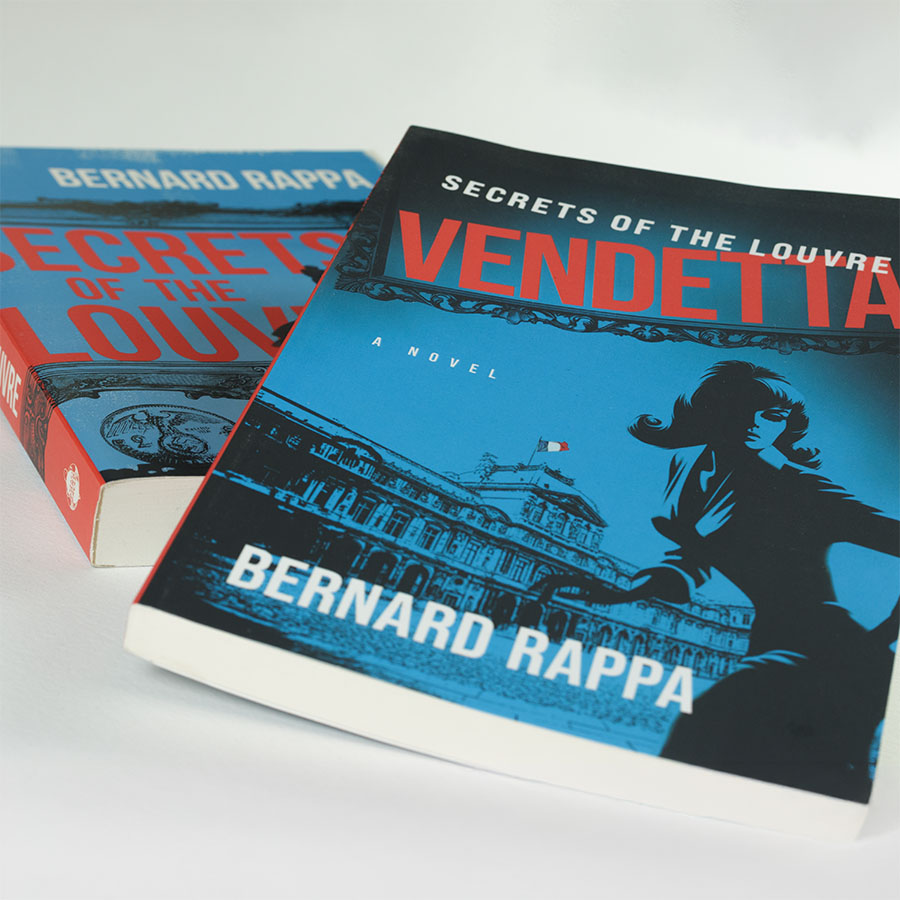 View of "Vendetta" cover on top of the earlier "Secrets of the Louvre" cover.